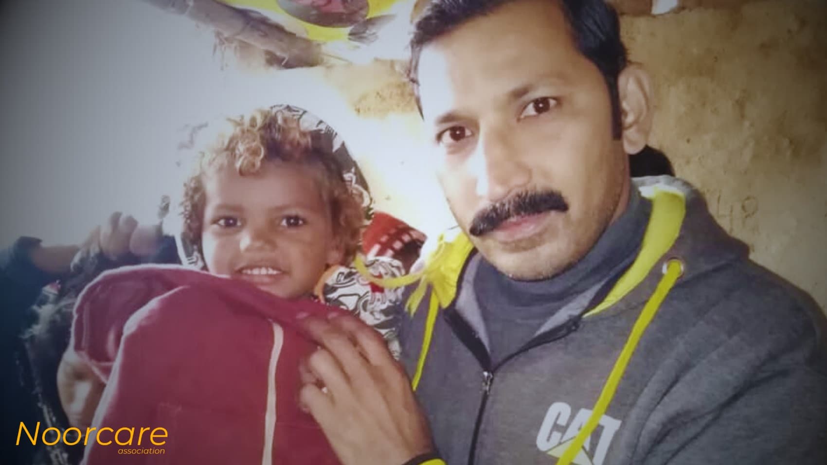 A volunteer with a small child