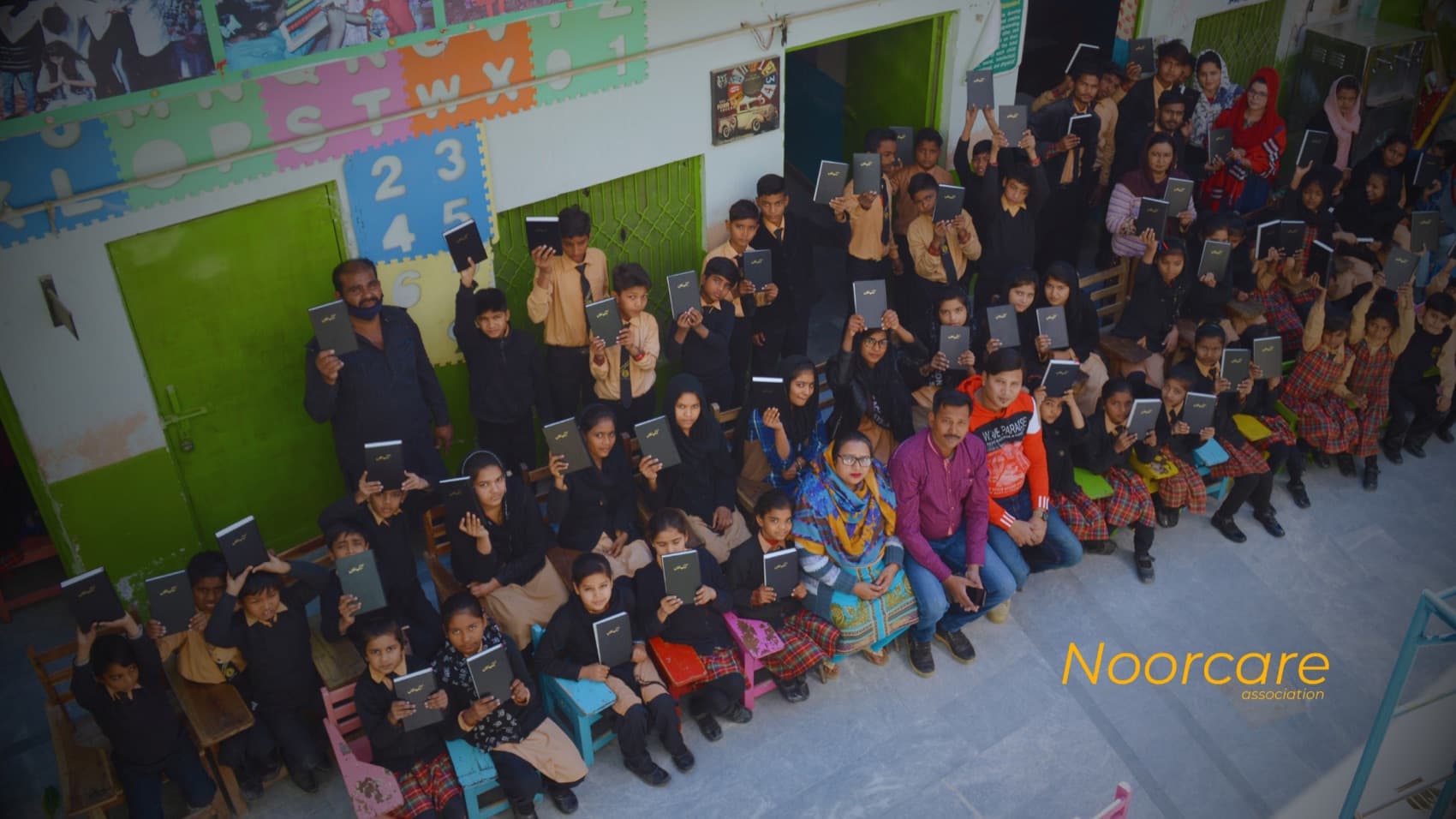 A classroom, full of hands raised high